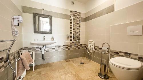 a bathroom with a toilet and a sink at Studio Poudrière in Ferrières-la-Verrerie
