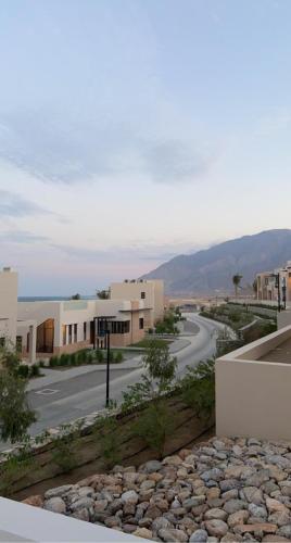 a view of a street with buildings and a road at Sifah seaCottage in Muscat
