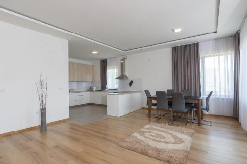 a dining room and kitchen with a table and chairs at pazaric residence in Doljani