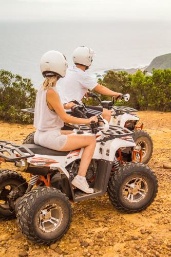 two people riding on a four wheeler on the beach at The Cacoon Tsitsikamma in Stormsriviermond