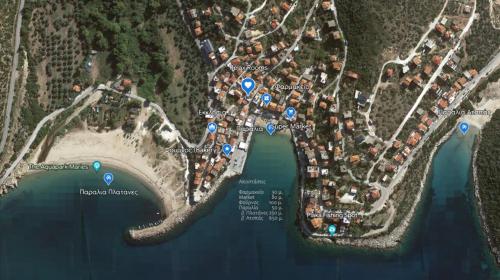 a map of a neighborhood with blue circles at RelaxRooms #1 in Skala Marion