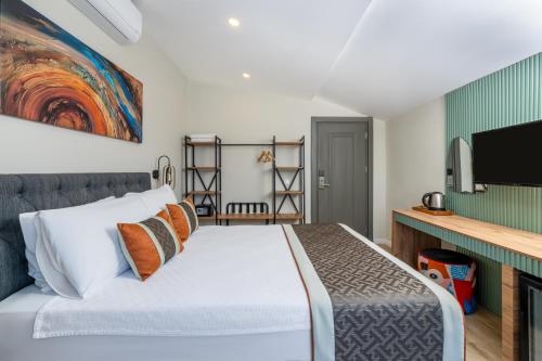 a bedroom with a bed and a flat screen tv at Echinus Lara Hotel in Antalya