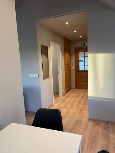 an empty room with a table and two chairs at Hvammur Apartments by the Harbour in Höfn