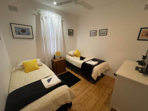a bedroom with two beds and a window at Black Cat Retreat holiday home in Nildottie