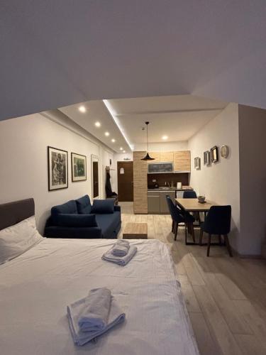 a bedroom with a bed and a living room at Kopaonik Apartmani Milmari - Katic in Kopaonik