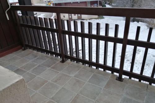 a balcony with a fence and a tile floor at Large south-facing studio in Saint-Pierre-de-Chartreuse