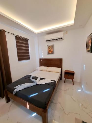 a bedroom with a bed in a room at Agateahs Place mini beach resort in Olongapo