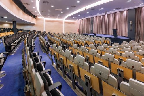 an empty lecture hall with rows of chairs at Gran Hotel Rey Don Jaime in Castelldefels