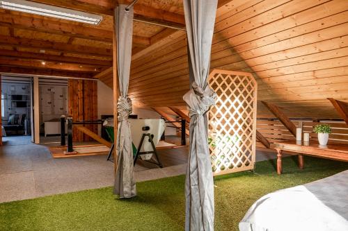 a bedroom with a wooden ceiling and green grass at Unique rustic property in skåne in Linderöd