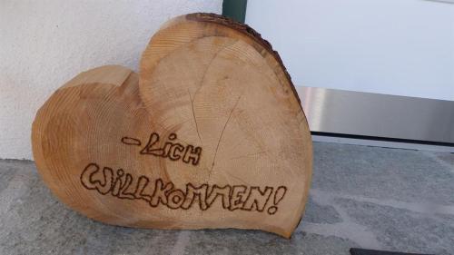 a piece of wood with the words autism achievement written on it at Multererhof in Nikolsdorf
