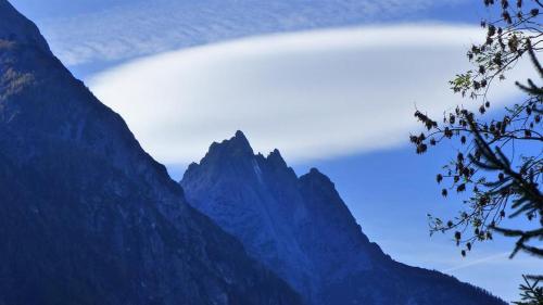 a mountain range with a cloud in the sky at Multererhof in Nikolsdorf
