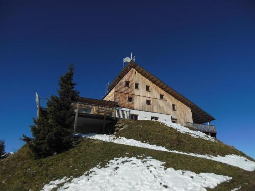 a building on top of a snow covered hill at Multererhof in Nikolsdorf