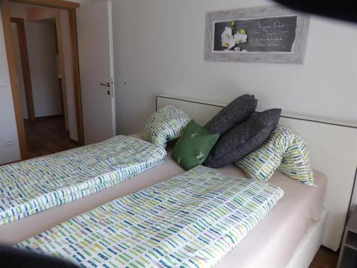 a couch with pillows and a bed in a room at Multererhof in Nikolsdorf