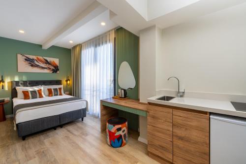 a bedroom with a bed and a sink at Echinus Lara Hotel in Antalya