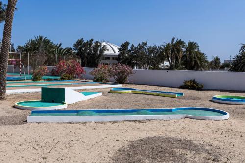 a group of trampolines in the sand in a park at Le Petit Palais Djerba & Spa in Houmt Souk