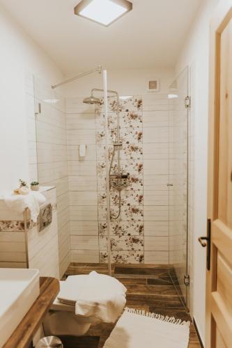 a bathroom with a shower and a sink at Neidhardt Vendégház in Bóly