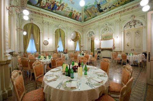 a dining room with tables and chairs in a building at Hotel Villa Malpensa in Vizzola Ticino