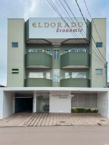 a building with a sign on the side of it at HOTEL ELDORADO ECONOMIC in Paracatu