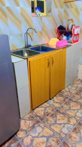a kitchen with a sink and a counter top at Service apartment in Kunkwaba