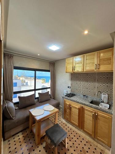 a living room with a couch and a table at Tirazir House 6 in Mirleft