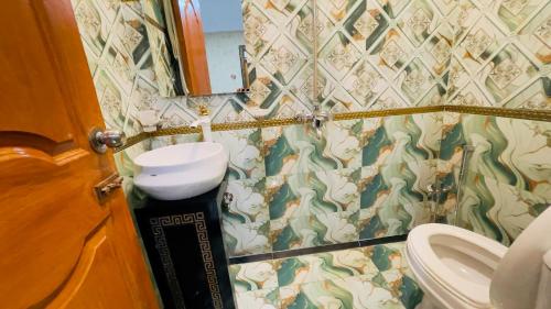 a bathroom with a sink and a toilet at Hotel New Mid City Multan in Multan