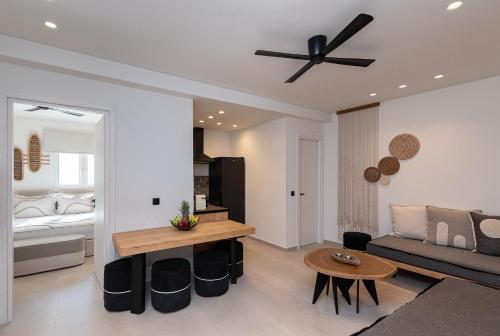 a living room with a couch and a ceiling fan at Aristotle Suites in Adamas