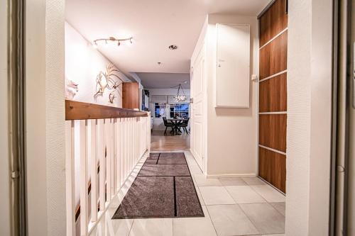 a hallway leading to a dining room with white walls at Levillas Skimbaajankuja 6 as3 in Levi
