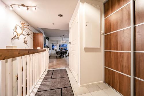 a hallway with a kitchen and a dining room at Levillas Skimbaajankuja 6 as3 in Levi