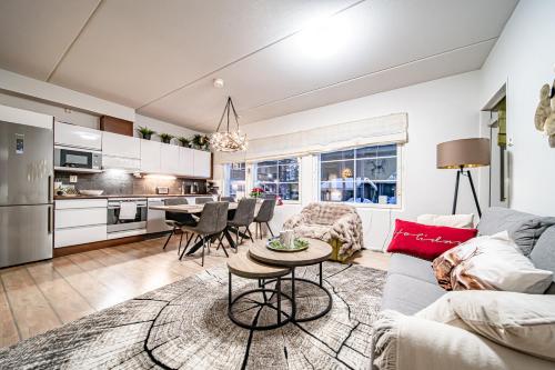 a living room with a couch and a table at Levillas Skimbaajankuja 6 as3 in Levi