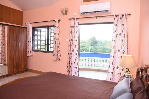a bedroom with a bed and a large window at Casa Maroquinha, 3bed Dona Paula in Panaji