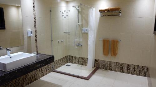 a bathroom with a shower and a sink at Beach safari nubian resort in Marsa Alam City