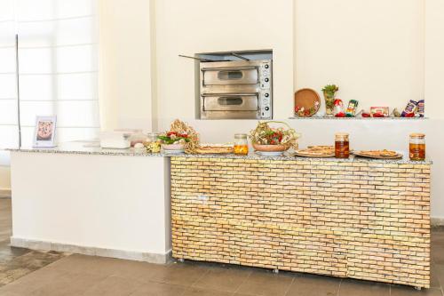 a kitchen with a counter with food on it at Le Petit Palais Djerba & Spa in Houmt Souk