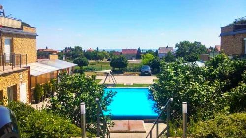 a view of a swimming pool in a parking lot at Koczor Apartman in Balatonfüred