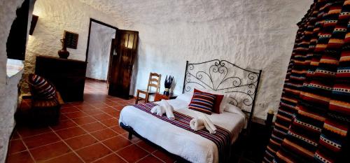 a bedroom with a bed in a room at Casa CUEVA CASCAMORRAS "Capricho Andaluz" in Baza