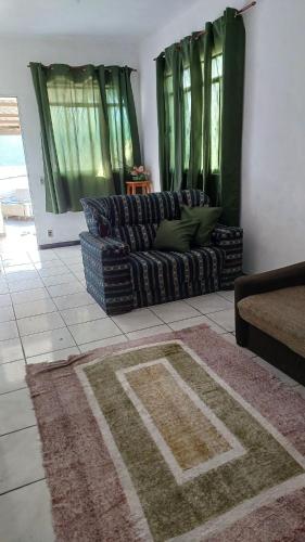 a living room with two couches and a rug at Cantinho dos Barbosas in Angra dos Reis
