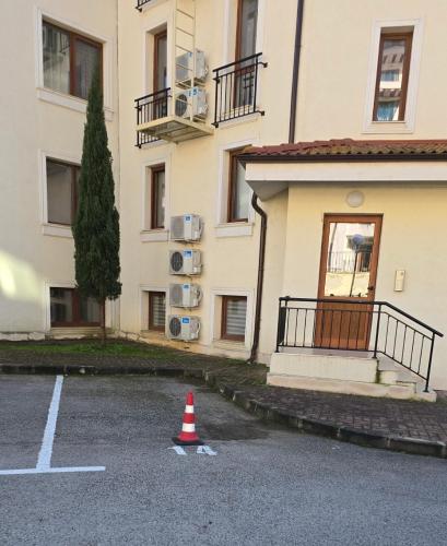 a cone in a parking lot in front of a building at Apartments Sea Sunrise, complex Carpe Diem, FREE PARKING in Balchik