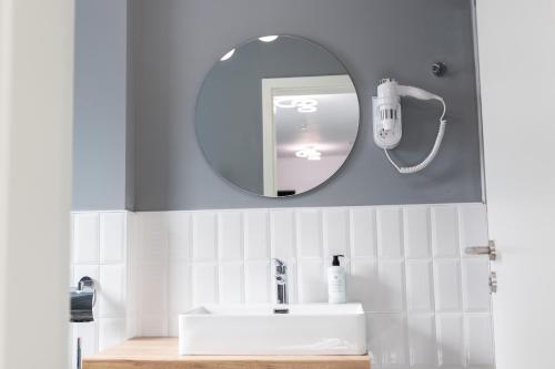 a bathroom with a sink and a mirror at Johann Strauss Hotel in Bucharest