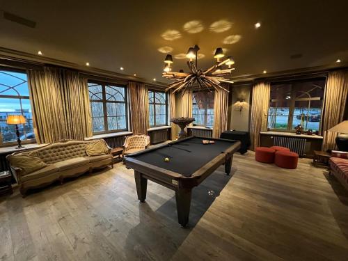 a living room with a pool table and a chandelier at LeSable luxury vacation home in Kluisbergen