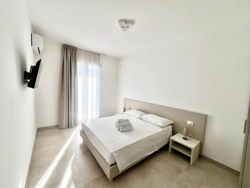 En eller flere senge i et værelse på ADAGIO by Verde Blu Vacanze