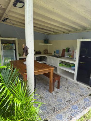 a kitchen with a wooden table in a room at Villa Anjing in Nusa Dua