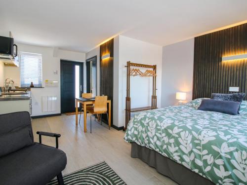 a bedroom with a bed and a desk and a kitchen at Stiper View Barn 1 in Shrewsbury
