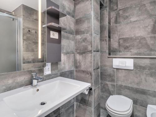 a bathroom with a sink and a toilet at B&B HOTEL Milano Ornato in Milan