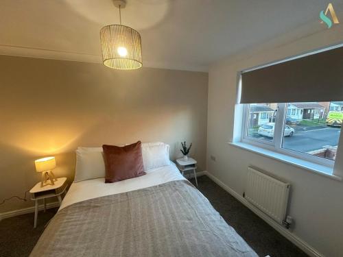 a bedroom with a bed and a window at Overton View in Stockton-on-Tees