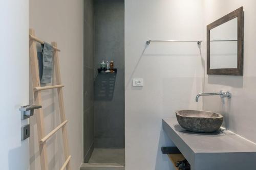 a bathroom with a sink with a mirror and a shower at Villa Petra in Plakias
