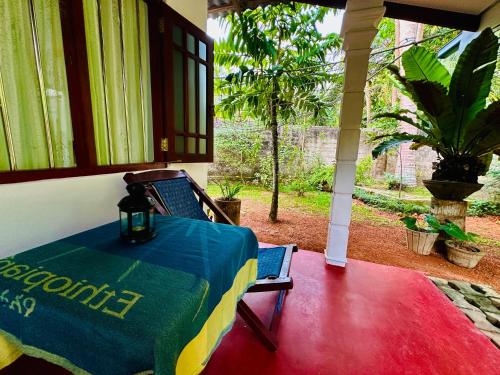 a table on the porch of a house at Coco Cabana Hikkaduwa in Hikkaduwa