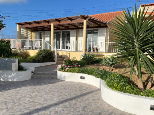 a house with a walkway in front of it at Casa das Malvas in Porto Santo