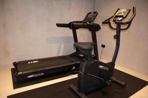 a treadmill with a cell phone on top of it at Lithos Art Villas in Sarlata