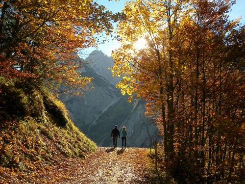 two people walking on a path in the mountains at Seeblick 11 in Zell am See