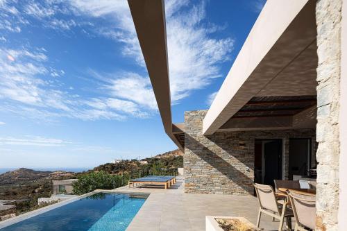 a villa with a swimming pool and a view at Villa Oniriko in Marioú