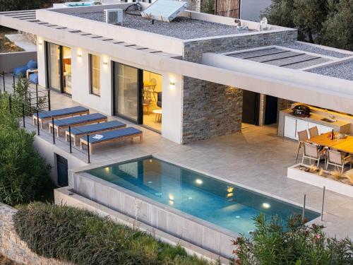 an external view of a house with a swimming pool at Villa Oniriko in Marioú